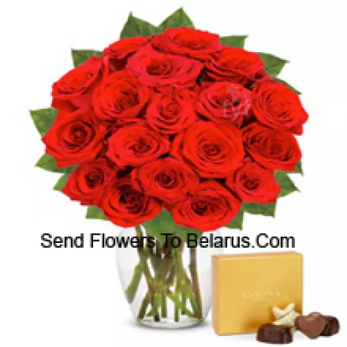 25 Red Roses With Some Ferns In A Glass Vase Accompanied With An Imported Box Of Chocolates