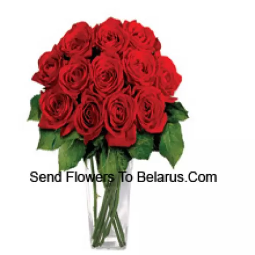 15 Red Roses With Some Ferns In A Glass Vase