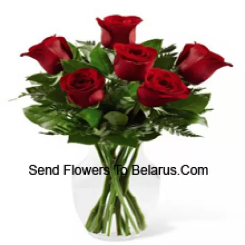 7 Red Roses With Some Ferns In A Glass Vase