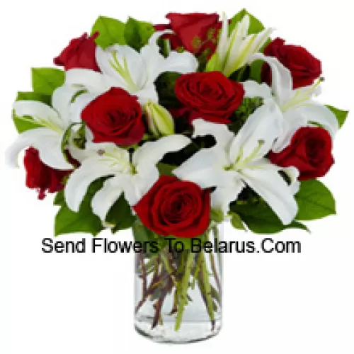 Red Roses And White Lilies With Seasonal Fillers In A Glass Vase