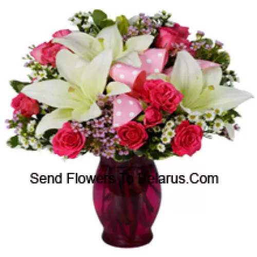 Pink Roses And White Lilies With Seasonal Fillers In A Glass Vase