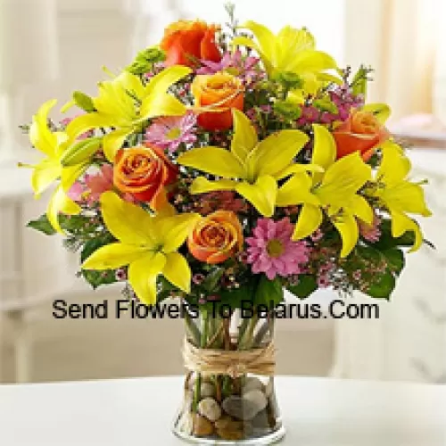 Yellow Lilies, Orange Roses And Pink Gerberas With Seasonal Fillers In A Glass Vase