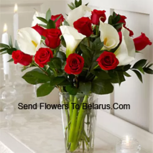 Red Roses And White Lilies With Some Ferns In A Glass Vase