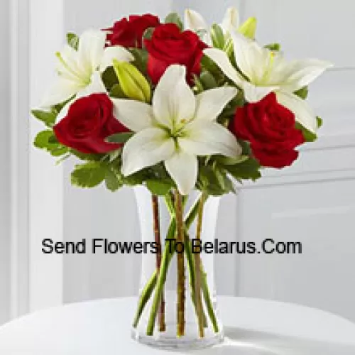 Red Roses And White Lilies With Some Seasonal Fillers In A Glass Vase