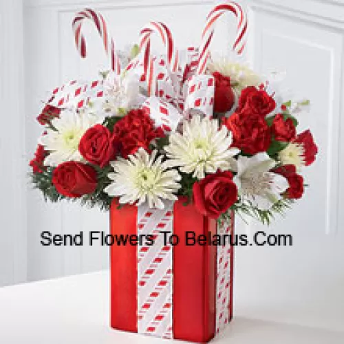 This Bouquet will dazzle them with its whimsical joy and spirited beauty! A gorgeous arrangement of white mums, red carnations and spray roses sit amongst holiday greens in a shiny red vase adorned with candy canes and wrapped to perfection with a beautiful bow, making it look like the finest holiday gift. (Please Note That We Reserve The Right To Substitute Any Product With A Suitable Product Of Equal Value In Case Of Non-Availability Of A Certain Product)